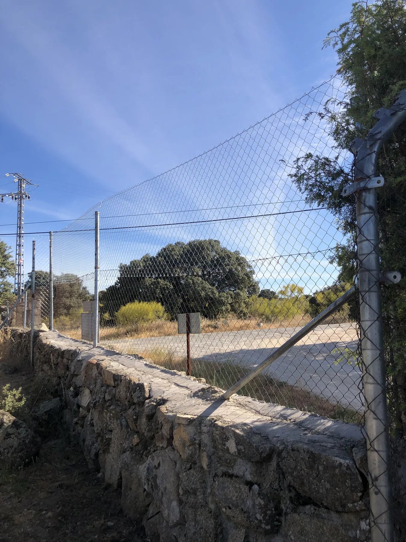 Cerramiento de malla metálica colocado sobre muro de mampostería